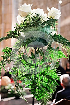 Decoration with fern leaves and white roses in a celebration inside an interior. Filicopsida photo
