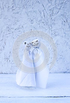 Decoration for Halloween. Two ghost figures on light background. Handmade decor for party.