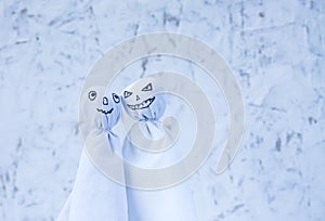 Decoration for Halloween. Two ghost figures on light background. Handmade decor for party.