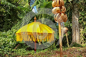 Decoration of Hindu temple complex Batukaru on Bali island in Indonesia. Yellow and white decorative umbrellas line the path for