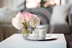 Aroma reed diffuser, candle and flowers on table photo