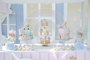 Decoration for kids birthday party at outdoor yard in the afternoon daylight. Bright color, blue and pink theme. Candy, Cake, Cook