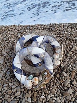 A decoration ring with net, shell, sand, sea etc. maritime motiv photo