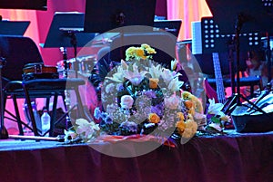 Decoration on the stage as a still life decorative flowers with colored curtains in the background