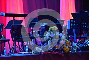 Decoration on the stage as a still life decorative flowers with colored curtains in the background