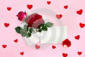 Decoration of Valentine Day. Beautiful flowers red roses in postal envelope and blank sheet with space for text and red petal