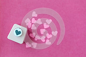Decoration for Valentine`s Day: hole puncher making paper shapes of hearts