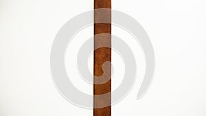 Dividing strip. Brown leather strap on a white background.