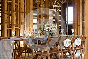 Decoration wedding table before a banquet in a wooden barn.