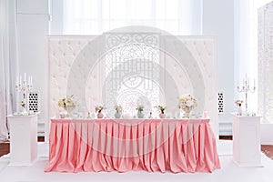 Decoration of wedding table with tender pink textile