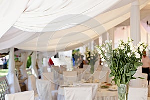Decoration of wedding table with tender white textile.