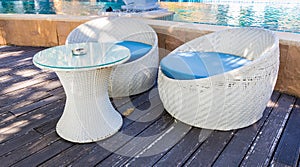 Decoration of  white Rattan chair side swimming pool-relax lifestyle of travel in Summer concept