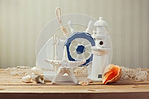 Decorations of marine lifestyle and seashells on wooden table over grunge background