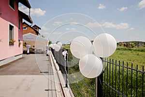 Decorations on the metal fence; decorated wedding party venue