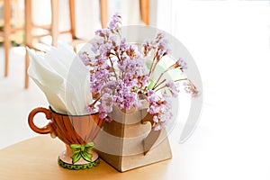 Decorations of Tiny gypso purple flowers in vase and napkin in cup