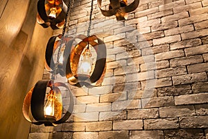 Decorative antique edison style filament light bulbs on brick wall background.