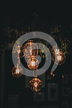 Decorative antique edison style filament light bulbs glowing in the dark