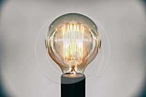 Decorative antique edison style light bulb.Beautiful retro luxury light lamp decor glowing selective focus film grain style effect