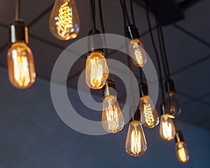 Decorative antique edison style light bulbs against brick wall background