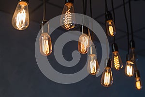 Decorative antique edison style light bulbs against brick wall background