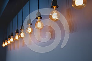 Decorative antique edison style light bulbs against wall background.