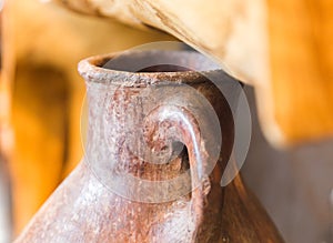 Decorative Antique Hand-Made Clay Pitcher in Sunlight
