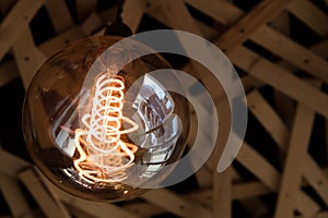 Decorative antique style light bulbs on the background of a mirror that reflects the light bulbs.