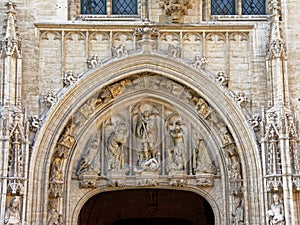 Decorative arch with statues above a door of the townhouse of Brussels, Belgium