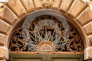 Decorative arched window above a door