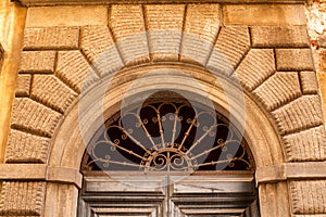 Decorative arched window above a door