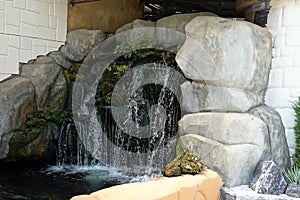 A decorative artificial waterfall in the garden. Landscape design