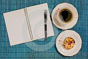 Decorative background coffee, notebook, pen and breackfast