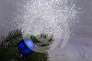 Decorative background with fir branches and blue balls on the silver. Christmas card Holiday Concept