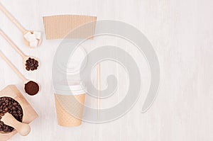 Decorative background for restaurant and coffee shop - blank paper cup, label, mortar with coffee beans, copy space on white wood.