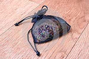 Decorative bag with beads on a wooden table