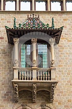 The decorative balcony has a city office building, Barcelona, Spain.