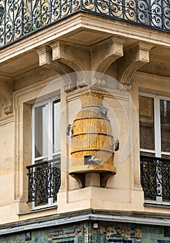 Decorative beehive on the wall of traditional parisian building