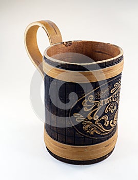 Decorative beer mug made of birch bark with the image of a fish, isolated on white close-up