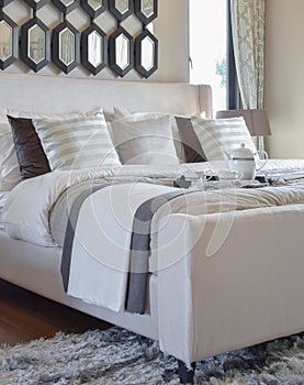 Decorative black tray of tea set on the bed in modern bedroom interior