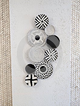 Decorative black and white patterned plates on a wall.