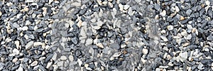 Decorative black and white pebble stones as background. Panorama
