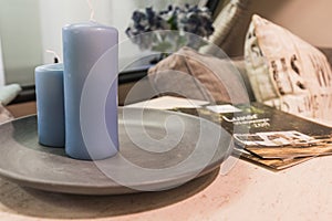 Decorative blue candles and a sale prospect on a table