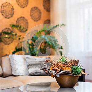 Decorative bouquet of flowers on the table in orange living room