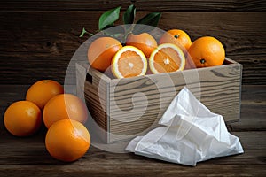 Decorative box of tissues and fresh oranges on a rustic table