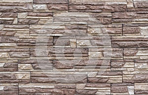 Decorative wall from a torn stone brick as a background or tex