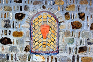 Decorative bricked window in a stone wall