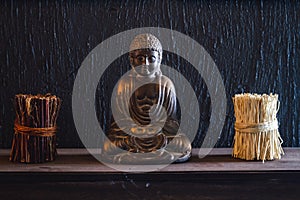 Decorative Bronze Budha Trinket on Wall Shelf of a Cafe Shop