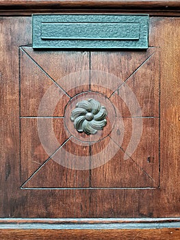 Decorative bronze elements of the wooden front door decoration