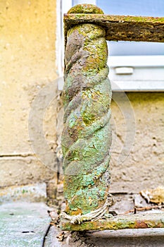 Decorative building detail rusty cast-iron twisted post from window fence
