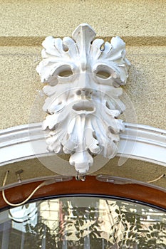 Decorative carved face on building facade